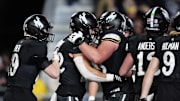 Oct 25, 2025; Laramie, Wyoming, USA; Wyoming Cowboys running back Sam Scott (22) celebrates his touchdown in the second half against the Colorado State Rams.