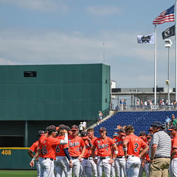 Jun 16, 2024; Omaha, NE, USA;  The Virginia Cavaliers meet on the field after the loss against the Florida State Seminoles at Charles Schwab Field Omaha. Mandatory Credit: Steven Branscombe-Imagn Images