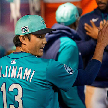 Seattle Mariners pitcher Shintaro Fujinami (13) celebrates with his team after pitching a scoreless seventh inning of a spring training game against the Los Angeles Dodgers at Peoria Sports Complex on March 7. 