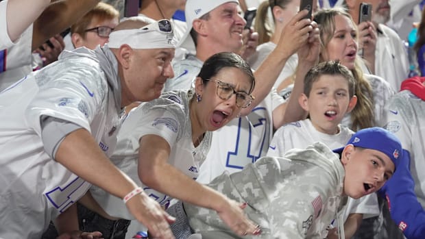Fans yell and scream cheering on the Bills as they warm up before the Bills home game against the Patriots.