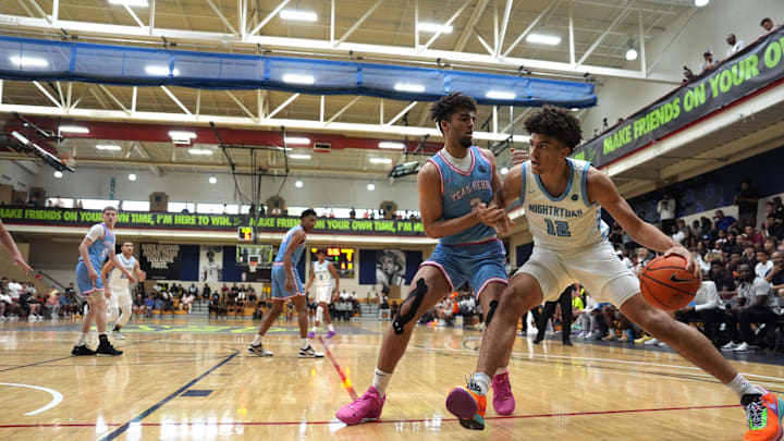 July 17, 2024; North Augusta, S.C., USA; Nightrydas Elite's Cameron Boozer (12) moves towards the basket as Team Herro's Xzavion Mitchell (2) defends during the Nightrydas Elite and Team Herro game at the Nike Peach Jam at Riverview Park Activities Center. Nightrydas Elite won 88-58. Mandatory Credit: Katie Goodale-USA TODAY Network