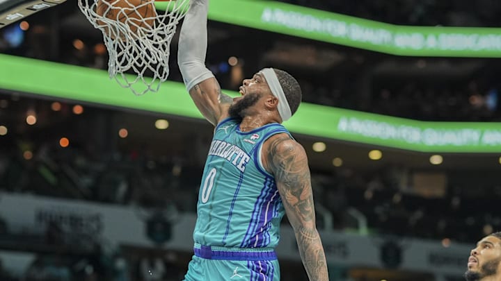 Apr 1, 2024; Charlotte, North Carolina, USA; Charlotte Hornets forward Miles Bridges (0) gets the dunk against the Boston Celtics during the second half at Spectrum Center. Mandatory Credit: Jim Dedmon-USA TODAY Sports