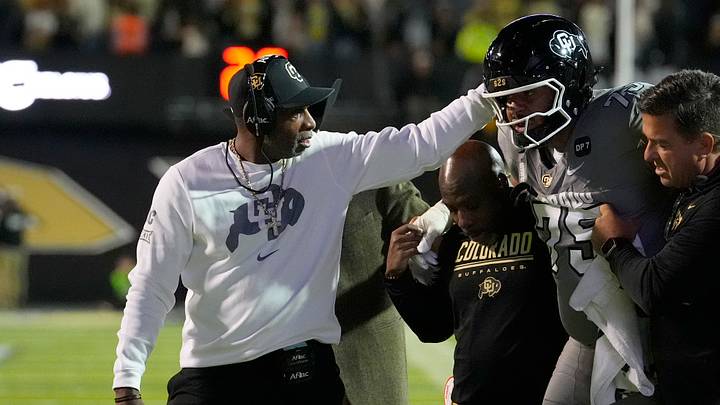 Oct 17, 2026; Boulder, Colorado, USA;  Colorado Buffaloes head coach Deion Sanders and offensive lineman Jayven Richardson (75) following an injury during the first quarter against the Utah Utes at Folsom Field.  Mandatory Credit: Ron Chenoy-Imagn Images