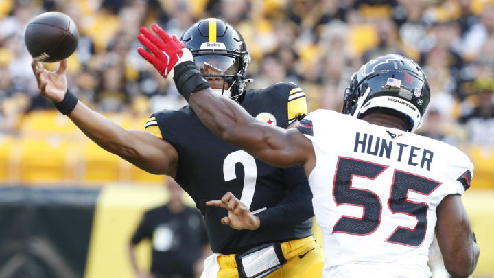 Aug 9, 2024; Pittsburgh, Pennsylvania, USA;  Pittsburgh Steelers quarterback Justin Fields (2) passes against pressure from Houston Texans defensive end Danielle Hunter (55) during the first quarter at Acrisure Stadium. Mandatory Credit: Charles LeClaire-USA TODAY Sports