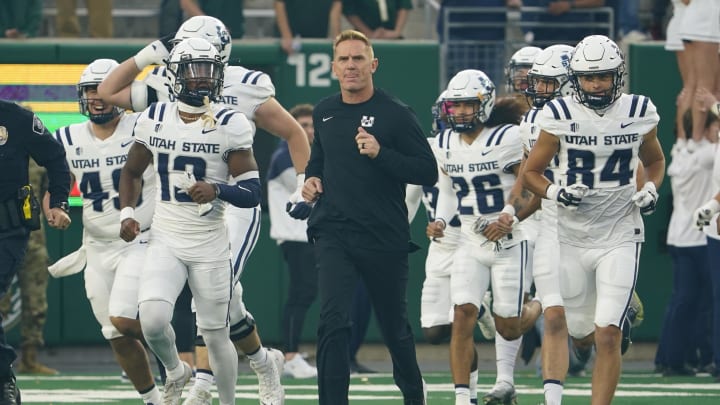 Oct 15, 2022; Fort Collins, Colorado, USA; Utah State Aggies head coach Blake Anderson leads his team onto the field at Sonny Lubick Field at Canvas Stadium. Mandatory Credit: Michael Madrid-USA TODAY Sports