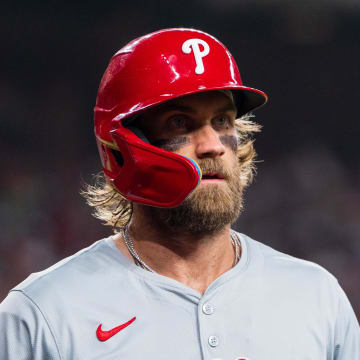 Aug 10, 2024; Phoenix, Arizona, USA;  Philadelphia Phillies infielder Bryce Harper reacts after getting stranded at first base.