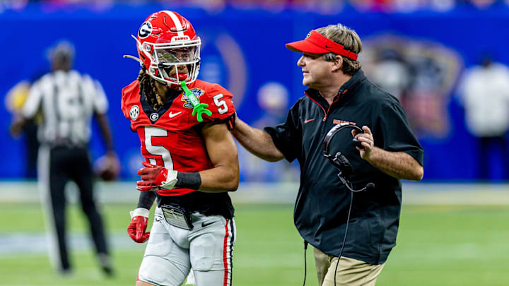 Jan 2, 2025; New Orleans, LA, USA;  Georgia Bulldogs head coach Kirby Smart talks to wide receiver Anthony Evans III (5) before the kick off from the Notre Dame Fighting Irish during the first half at Caesars Superdome. Mandatory Credit: Stephen Lew-Imagn Images