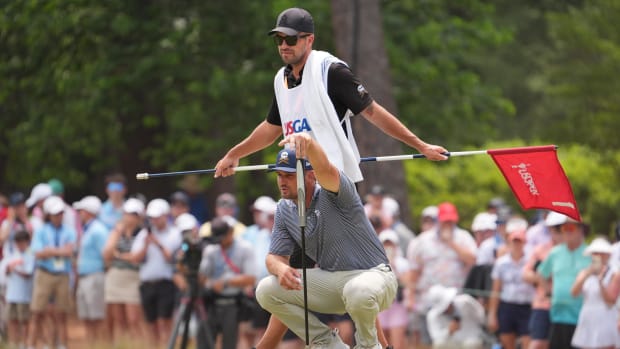 Former Mustangs golfer Bryson DeChambeau lining up a putt with caddie Gregory Bodine.
