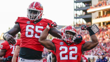 Georgia Bulldogs running back Branson Robinson (22) reacts with offensive lineman Amarius Mims (65)