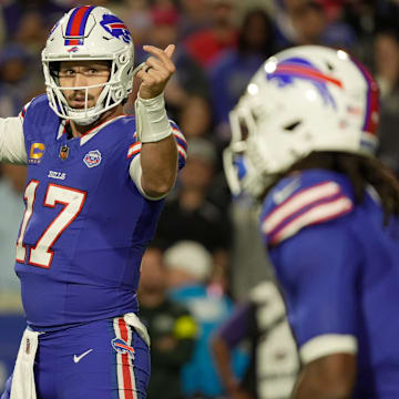 Buffalo Bills QB Josh Allen signals to running back James Cook during first-half action against the Baltimore Ravens.