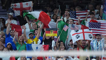Aug 11, 2024; Paris, France; Fans cheer and wave flags in the women's volleyball gold medal match between United States and Italy during the Paris 2024 Olympic Summer Games at South Paris Arena. Mandatory Credit: Amber Searls-Imagn Images