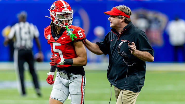 Jan 2, 2025; New Orleans, LA, USA;  Georgia Bulldogs head coach Kirby Smart talks to wide receiver Anthony Evans III (5) before the kick off from the Notre Dame Fighting Irish during the first half at Caesars Superdome. Mandatory Credit: Stephen Lew-Imagn Images