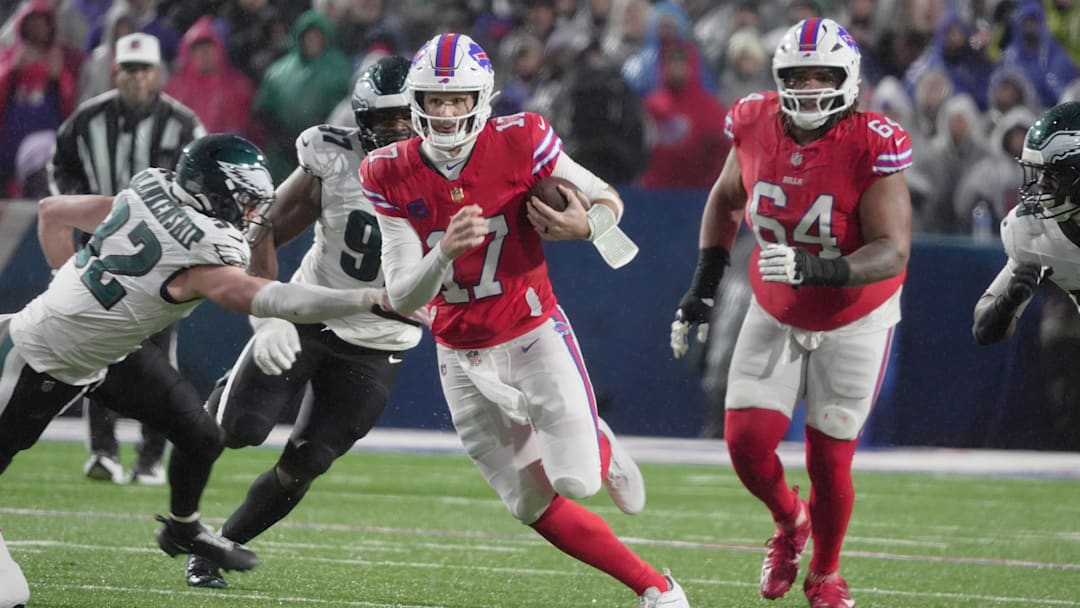 Buffalo Bills quarterback Josh Allen runs with the ball for several yards before being tripped up by Philadelphia Eagles linebacker Jalyx Hunt during first half action against the Philadelphia Eagles at Highmark Stadium in Orchard Park on Dec. 28, 2025.