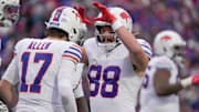 Bills tight end Dawson Knox high fives quarterback Josh Allen after one of Allen's three rushing touchdowns on the day. 
