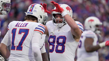 Bills tight end Dawson Knox high fives quarterback Josh Allen after one of Allen's three rushing touchdowns on the day. 