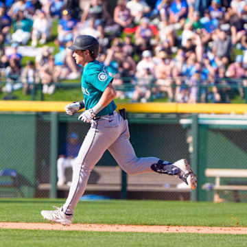 Mar 8, 2025; Mesa, Arizona, USA; Seattle Mariners infielder Colt Emerson (85) hits a home run in the top of the ninth during a spring training game against the Chicago Cubs at Sloan Park. Mandatory Credit: Allan Henry-Imagn Images