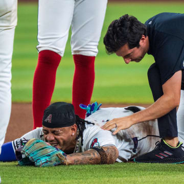 Aug 10, 2024; Phoenix, Arizona, USA; Arizona Diamondbacks infielder Ketel Marte (4) reacts after a collision with Philadelphia Phillies catcher Garrett Stubbs (21) (not shown) at second base in the fourth inning during a game against the Philadelphia Phillies at Chase Field. Mandatory Credit: Allan Henry-USA TODAY Sports  