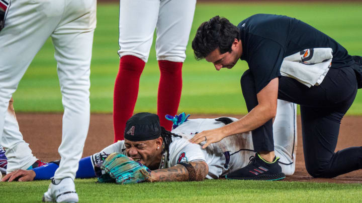 Aug 10, 2024; Phoenix, Arizona, USA; Arizona Diamondbacks infielder Ketel Marte (4) reacts after a collision with Philadelphia Phillies catcher Garrett Stubbs (21) (not shown) at second base in the fourth inning during a game against the Philadelphia Phillies at Chase Field. Mandatory Credit: Allan Henry-USA TODAY Sports  