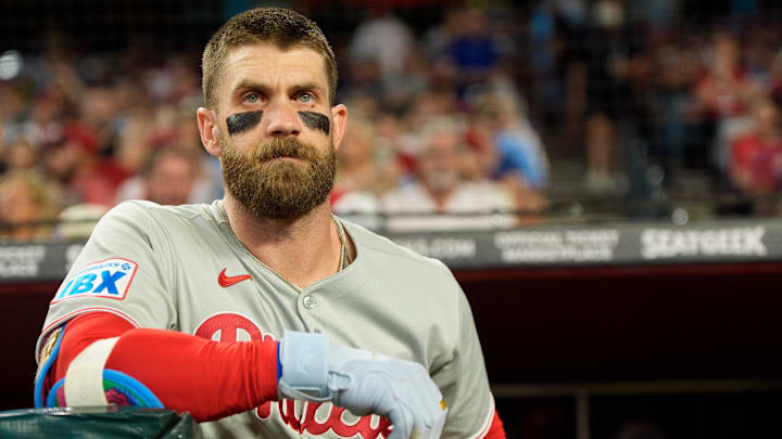 Philadelphia Phillies infielder Bryce Harper watches on from the dugout against the Arizona Diamondbacks