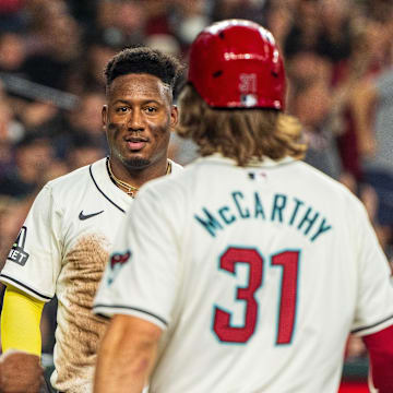 Sep 15, 2024; Phoenix, Arizona, USA; Arizona Diamondbacks infielder Geraldo Perdomo (2) reacts with outfielder Jake McCarthy (31) and infielder Josh Bell (21) after scoring in the third inning during a game against the Milwaukee Brewers at Chase Field. Mandatory Credit: Allan Henry-USA TODAY Sports