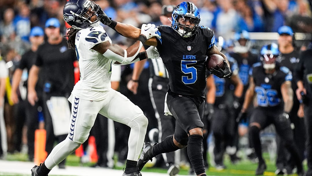 Sep 30, 2024; Detroit, MI, USA; Detroit Lions running back David Montgomery (5) runs for a first down against Seattle Seahawks safety Rayshawn Jenkins (2) during the second half at Ford Field in Detroit on Monday, Sept. 30, 2024. Mandatory Credit:  Junfu Han/USA TODAY NETWORK via Imagn Images
