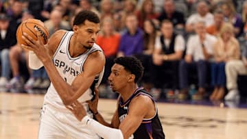 Nov 2, 2025; Phoenix, Arizona, USA; San Antonio Spurs forward Victor Wembanyama (1) drives against Phoenix Suns forward Ryan Dunn (0) during the first half at PHX Arena. Mandatory Credit: Allan Henry-Imagn Images