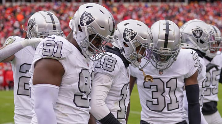 Dec 25, 2023; Kansas City, Missouri, USA; Las Vegas Raiders cornerback Jack Jones (18) celebrates with team mates against the Kansas City Chiefs after scoring during the first half at GEHA Field at Arrowhead Stadium. Mandatory Credit: Denny Medley-USA TODAY Sports