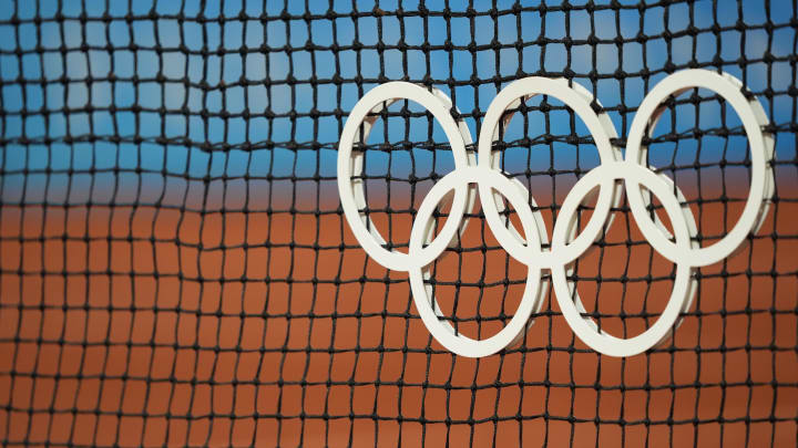 Jul 27, 2024; Paris, France; Olympic rings on the net in women's singles action during the Paris 2024 Olympic Summer Games at Stade Roland Garros. 