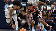 Mar 14, 2024; Nashville, TN, USA; Texas A&M Aggies forward Andersson Garcia (left) and Mississippi Rebels guard Matthew Murrell (11) work for a loose ball during the first half at Bridgestone Arena. Mandatory Credit: Christopher Hanewinckel-Imagn Images