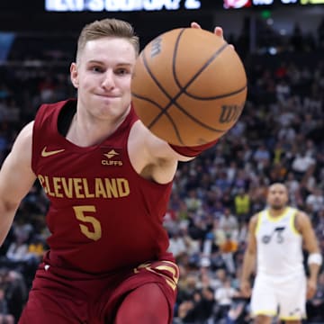 Apr 2, 2024; Salt Lake City, Utah, USA; Cleveland Cavaliers guard Sam Merrill (5) reaches for a loose ball against the Utah Jazz during the fourth quarter at Delta Center. Mandatory Credit: Rob Gray-Imagn Images