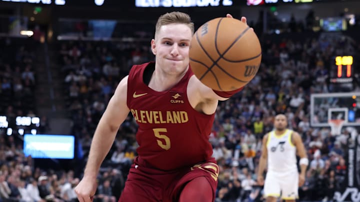 Apr 2, 2024; Salt Lake City, Utah, USA; Cleveland Cavaliers guard Sam Merrill (5) reaches for a loose ball against the Utah Jazz during the fourth quarter at Delta Center. Mandatory Credit: Rob Gray-Imagn Images