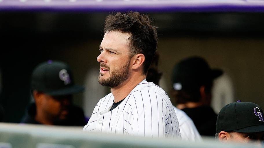 Colorado Rockies designated hitter Kris Bryant (23) looks on from the dugout