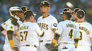 Jul 12, 2025; San Diego, California, USA; San Diego Padres pitching coach Ruben Niebla (57) talks with starting pitcher Yu Darvish (11) during a mound visit in the fifth inning against the Philadelphia Phillies at Petco Park. Mandatory Credit: David Frerker-Imagn Images