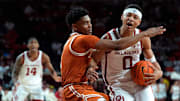 Oklahoma Sooners guard Jeremiah Fears (0) is fouled by Texas Longhorns guard Julian Larry (1) during an SEC men's college basketball game between the University of Oklahoma Sooners (OU) and the Texas Longhorns at Lloyd Noble Center in Norman, Okla., Wednesday, Jan. 15, 2025. Texas won 77-73.