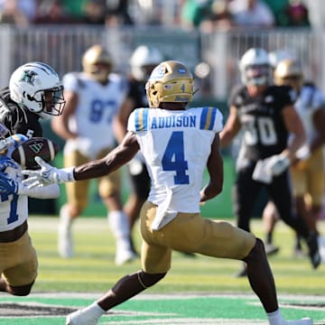 Aug 31, 2024; Honolulu, Hawaii, USA; UCLA Bruins defensive back K.J. Wallace (7) can’t pull in an interception over Hawaii Rainbow Warriors wide receiver Pofele Ashlock (5) during the fourth quarter of an NCAA college football game at the Clarence T.C. Ching Athletics Complex. Mandatory Credit: Marco Garcia-Imagn Images