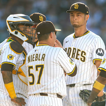 Jul 12, 2025; San Diego, California, USA; San Diego Padres pitching coach Ruben Niebla (57) talks with starting pitcher Yu Darvish (11) during a mound visit in the fifth inning against the Philadelphia Phillies at Petco Park. Mandatory Credit: David Frerker-Imagn Images