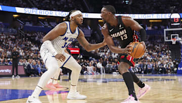 Oct 22, 2025; Orlando, Florida, USA; Miami Heat center Bam Adebayo (13) is guarded by Orlando Magic center Wendell Carter Jr. (34) in the second quarter at Kia Center. Mandatory Credit: Nathan Ray Seebeck-Imagn Images