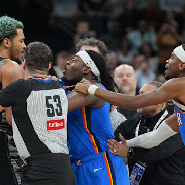 Mar 2, 2025; San Antonio, Texas, USA;  San Antonio Spurs forward Jeremy Sochan (10) and Oklahoma City Thunder guard Luguentz Dort (5) in the middle of an altercation during the second half at Frost Bank Center. Mandatory Credit: Daniel Dunn-Imagn Images