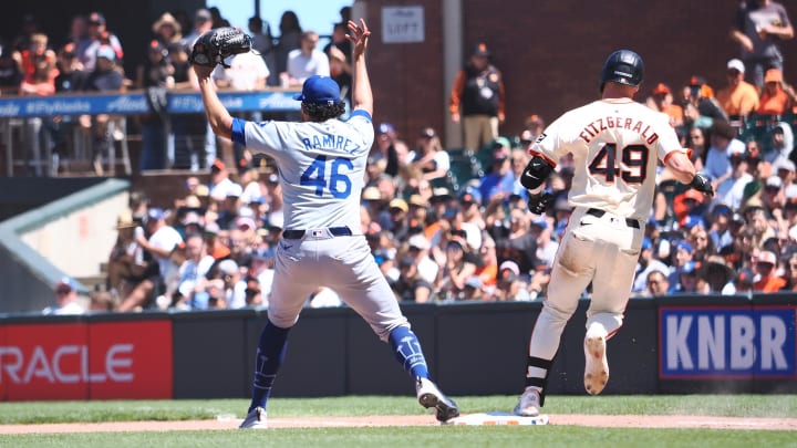 Jun 30, 2024; San Francisco, California, USA; Los Angeles Dodgers relief pitcher Yohan Ramirez (46) calls for the ball as San Francisco Giants second baseman Tyler Fitzgerald (49) safely reaches fist base during the seventh inning at Oracle Park. Mandatory Credit: Kelley L Cox-USA TODAY Sports