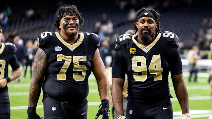 Sep 8, 2024; New Orleans, Louisiana, USA;  New Orleans Saints offensive tackle Taliese Fuaga (75) and defensive end Cameron Jordan (94) head to the locker room after the game against the Carolina Panthers at Caesars Superdome. Mandatory Credit: Stephen Lew-Imagn Images