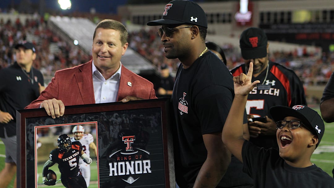 Sep 18, 2021; Lubbock, Texas, USA; Former Texas Tech Red Raiders and former NFL player Michael Crabtree is inducted into the Texas Tech Ring of Honor by Texas Tech athletic director Kirby Hocutt during half time of the Florida International Panthers game at Jones AT&T Stadium. Mandatory Credit: Michael C. Johnson-Imagn Images