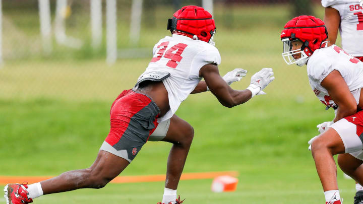 Adepoju Adebawore (34) runs drills during OU football practice