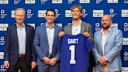 Apr 25, 2025; East Rutherford, NJ, US; New York Giants president John Mara (far left), general manager Joe Schoen (left), Jaxson Dart, and head coach Brian Daboll (right) pose for photos prior to the start of the press conference to introduce the Giants first round draft picks.   