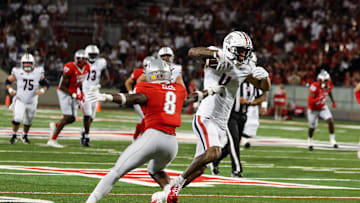 Aug 31, 2024; Tucson, Arizona, USA; Arizona Wildcats wide receiver Tetairoa McMillan (4) dodges tackle by New Mexico Lobos safety Christian Ellis (8) during third quarter at Arizona Stadium. Mandatory Credit: Aryanna Frank-Imagn Images