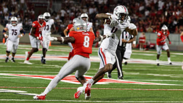 Aug 31, 2024; Tucson, Arizona, USA; Arizona Wildcats wide receiver Tetairoa McMillan (4) dodges tackle by New Mexico Lobos safety Christian Ellis (8) during third quarter at Arizona Stadium.