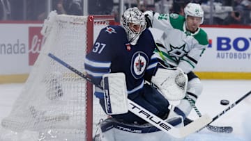 May 15, 2025; Winnipeg, Manitoba, CAN; Winnipeg Jets goalie Connor Hellebuyck (37) watches a Dallas Stars shot during the first period in game five of the second round of the 2025 Stanley Cup Playoffs at Canada Life Centre. Mandatory Credit: Terrence Lee-Imagn Images