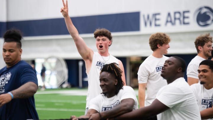 Penn State quarterback Drew Allar supports the offensive line as they face off against the defensive line in a game of tug of war during the 21st annual Lift for Life in Holuba Hall. 