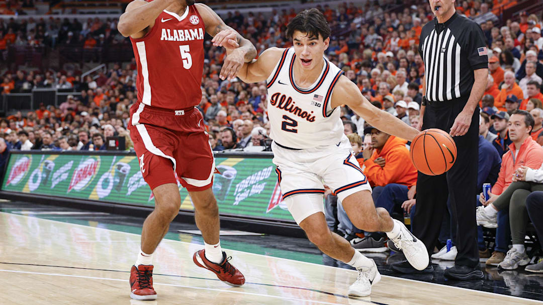 Nov 19, 2025; Chicago, Illinois, USA; Illinois Fighting Illini guard Andrej Stojakovic (2) drives to the basket against Alabama Crimson Tide forward Amari Allen (5) during the first half at United Center. Mandatory Credit: Kamil Krzaczynski-Imagn Images