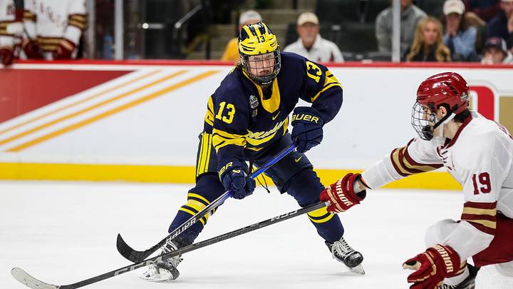 Michigan forward T.J. Hughes (13) shoots the puck against Boston College forward Cutter Gauthier (19) during the third period of the Frozen Four semifinal game at Xcel Energy Center in St. Paul, Minn. on Thursday, April 11, 2024. Michigan forward T.J. Hughes (13) shoots the puck against Boston College forward Cutter Gauthier (19) during the third period of the Frozen Four semifinal game at Xcel Energy Center in St. Paul, Minn. on Thursday, April 11, 2024.