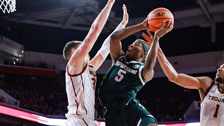 Feb 1, 2025; Los Angeles, California, USA;  Michigan State Spartans guard Tre Holloman (5) shoots the ball against the USC Trojans at Galen Center. Mandatory Credit: William Navarro-Imagn Images
